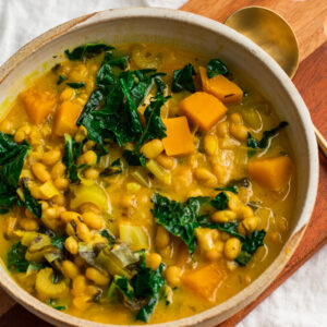 vegan golden harvest soup with kale leeks white beans and squash