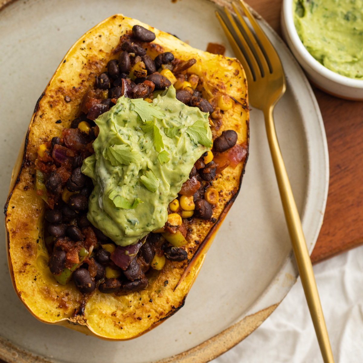 vegan stuffed spaghetti squash with avocada crema