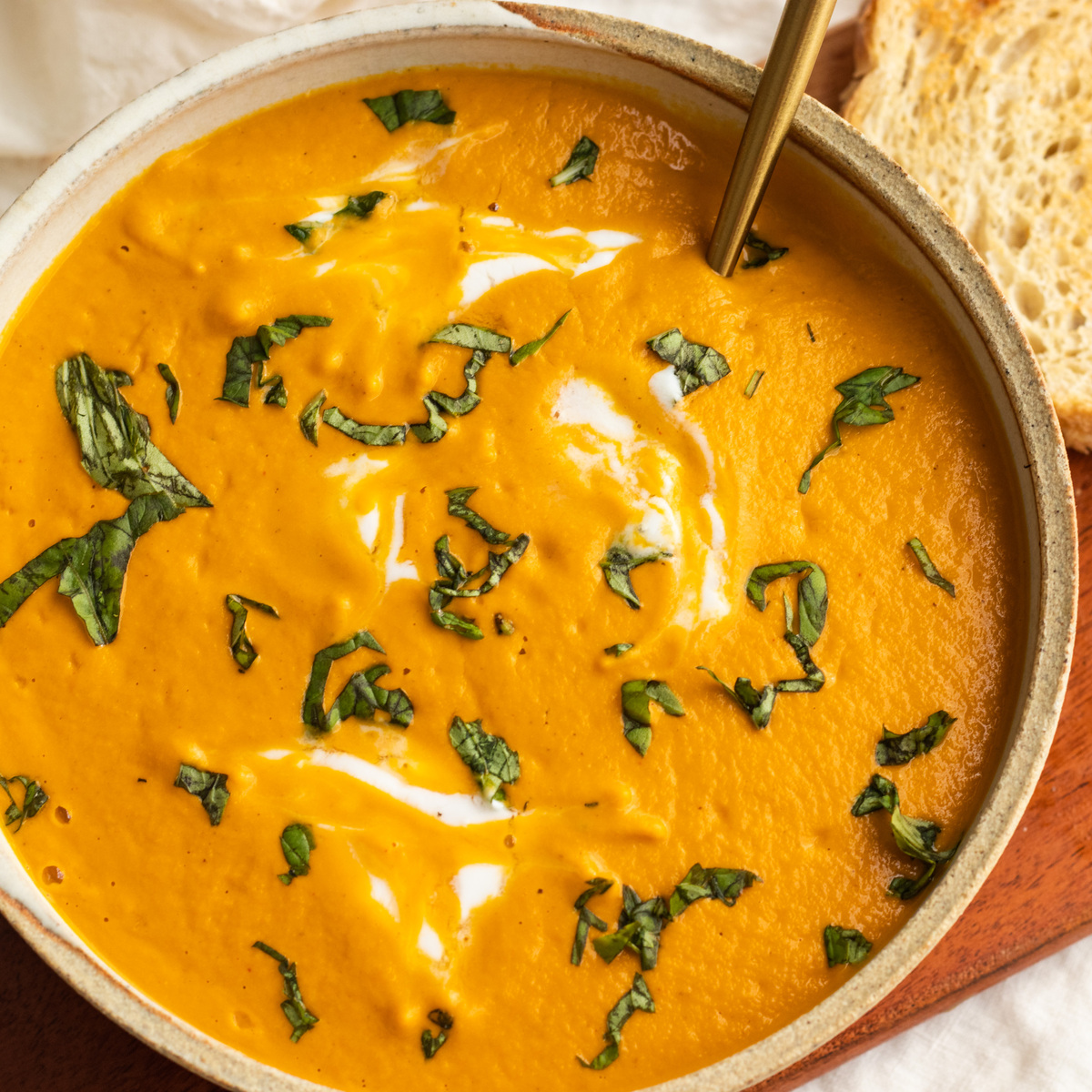 vegan creamy carrot tomato soup with cashews and basil