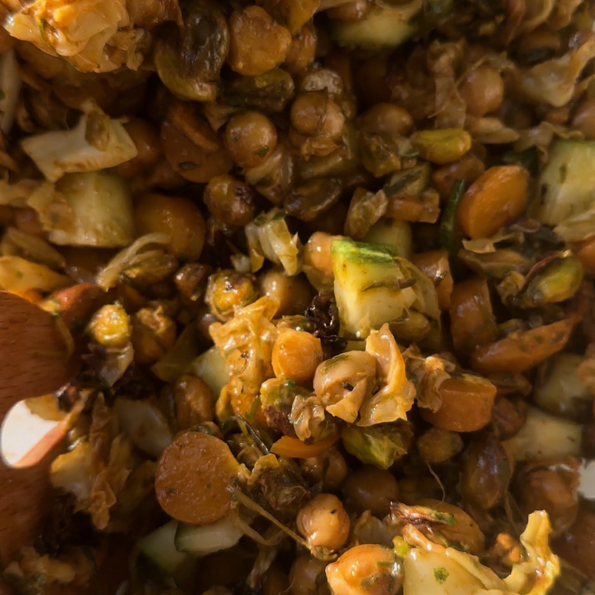 process shot step 3 of making baked cabbage, carrot and chickpea salad (vegan). Toss dressing with salad ingredients.