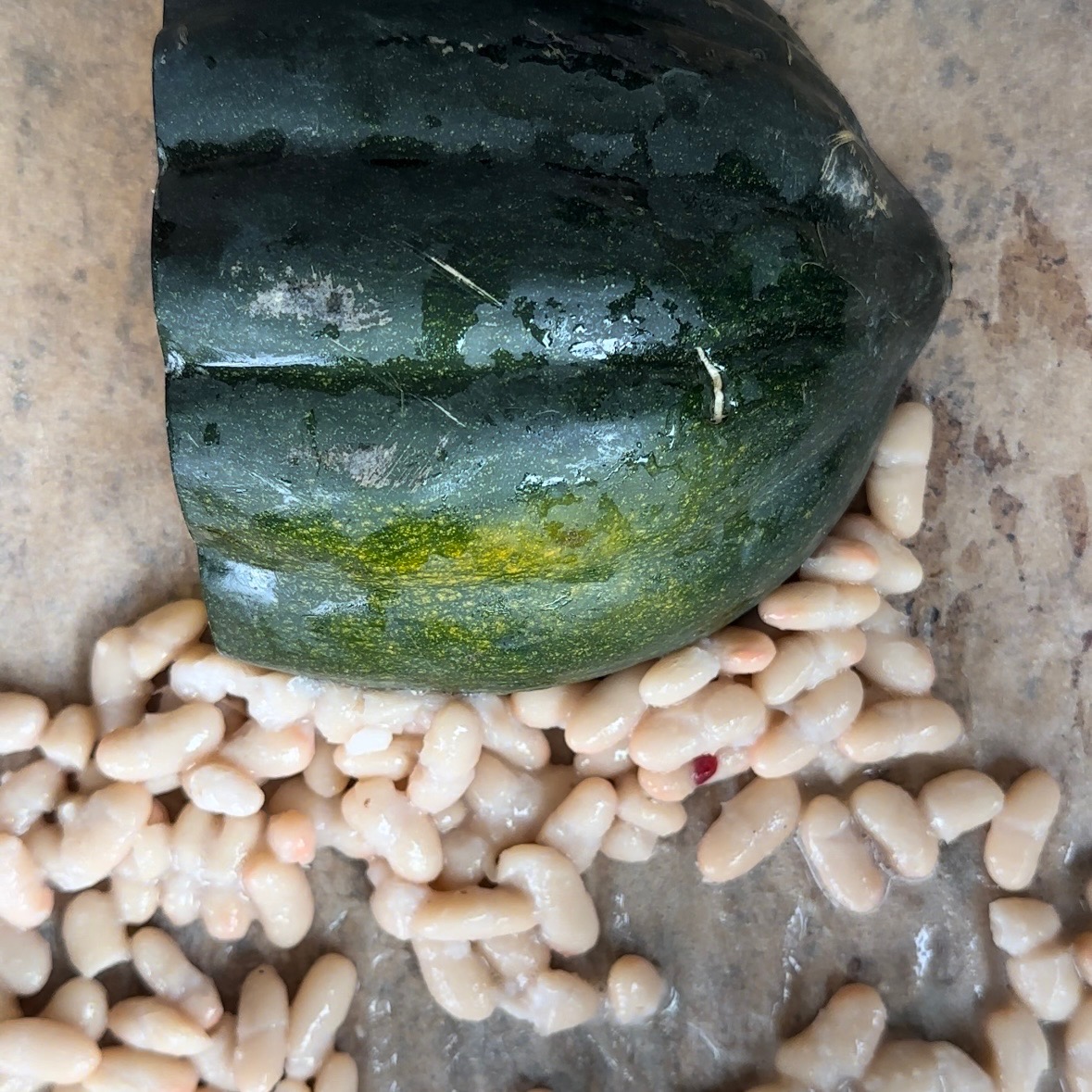 white beans and acorn squash on a sheet pan