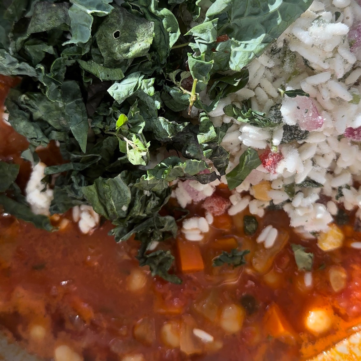 kale and rice in pot with soup