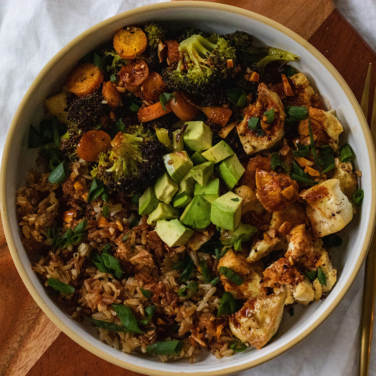 fried rice topped with avocado and scallions