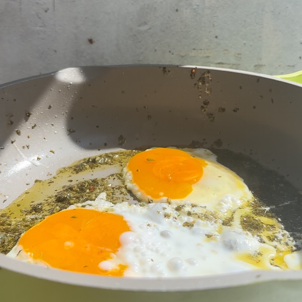 eggs in pan with chimichurri sauce