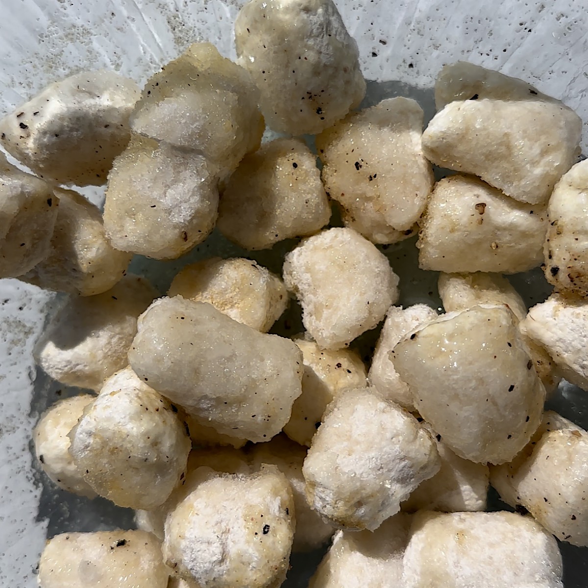 gnocchi in bowl with oil and spices