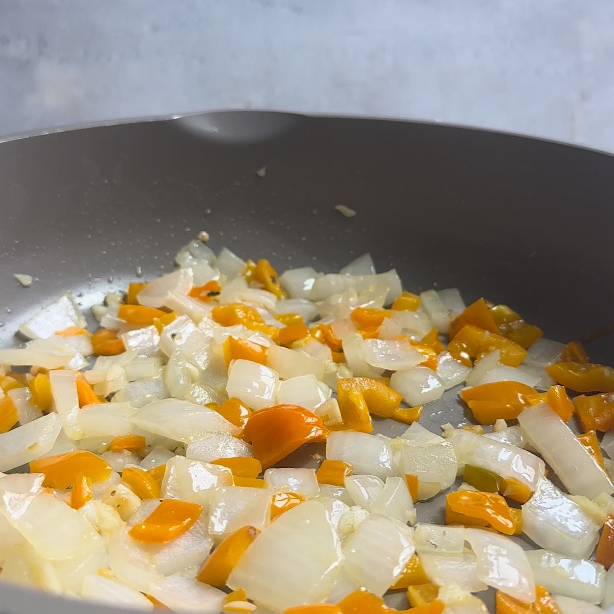 onions and peppers in pan