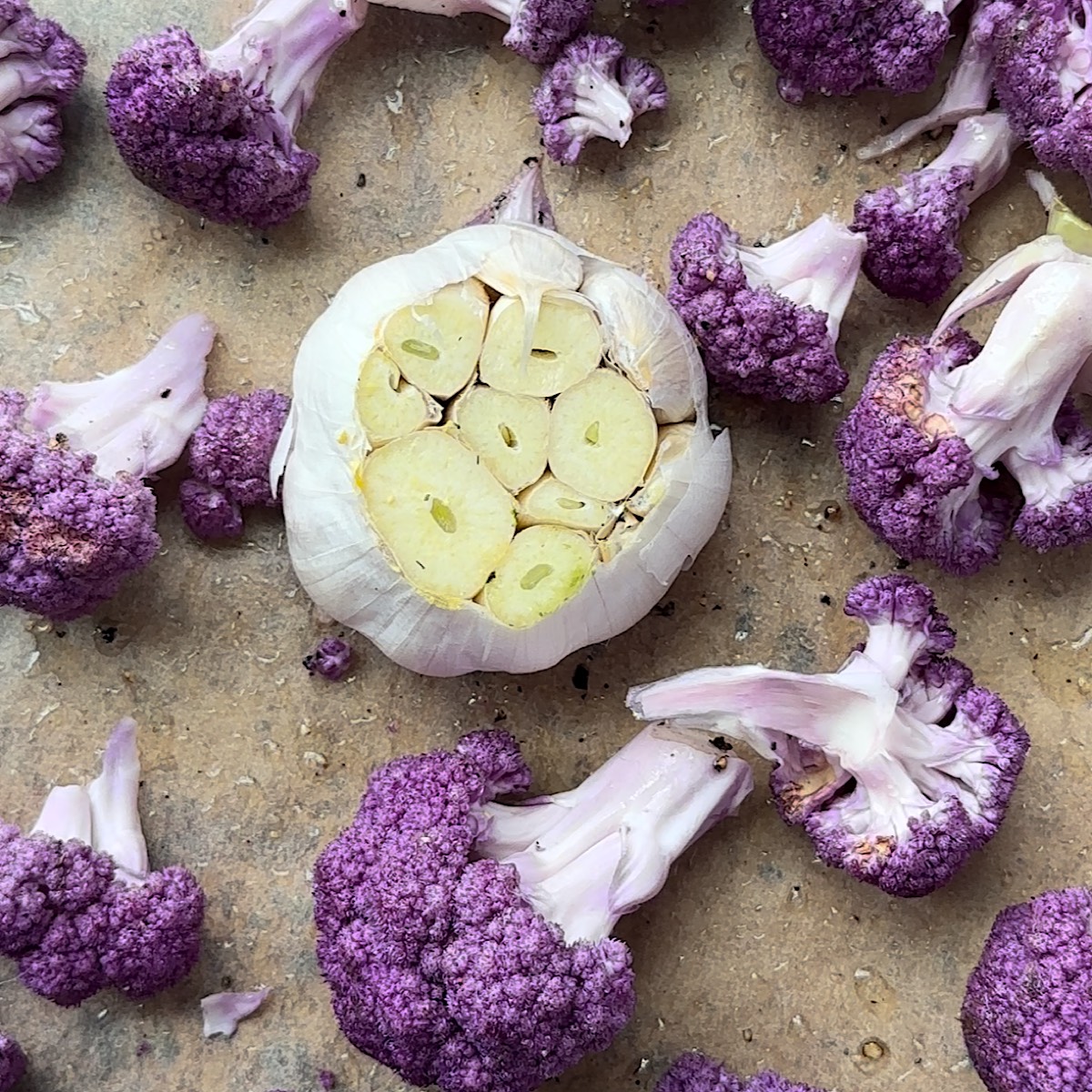 cauliflower and garlic on a sheet pan