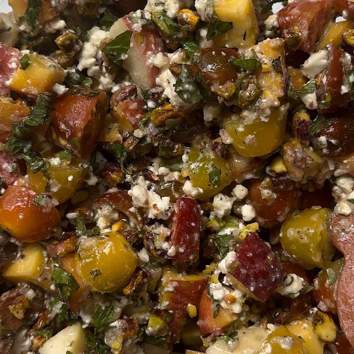 peach tomato salad in mixing bowl