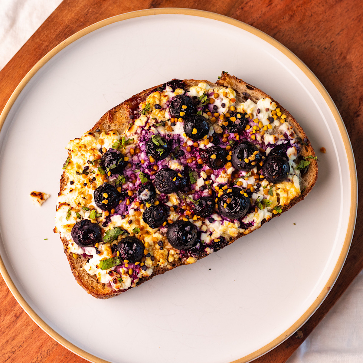 air fryer cottage cheese toast with blueberries and honey.