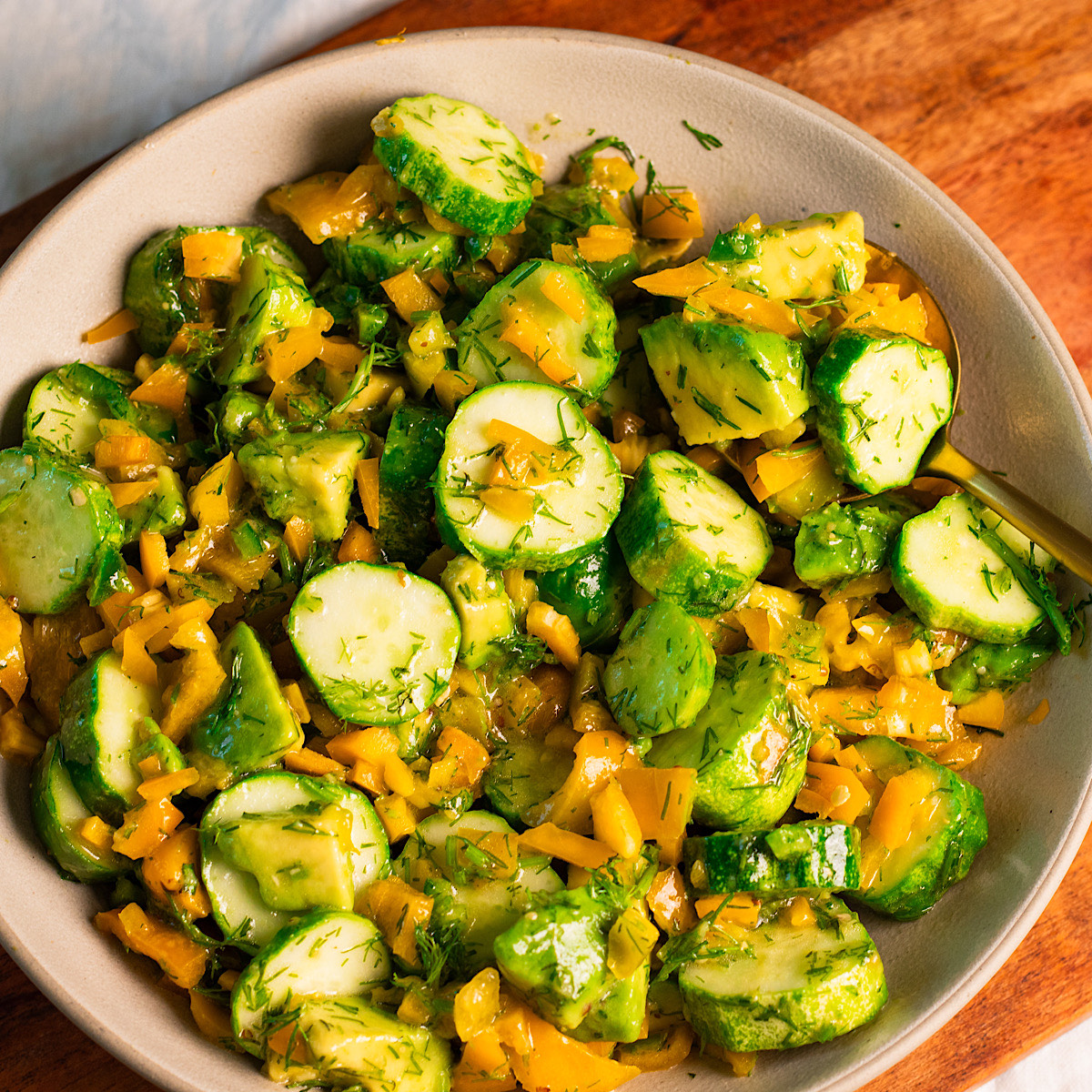 cucumber sweet pepper and avocado salad with lemon honey mustard dressing.