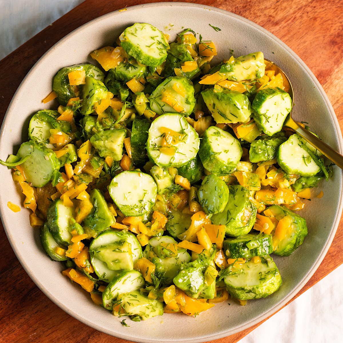 cucumber sweet pepper and avocado salad with lemon honey mustard dressing.