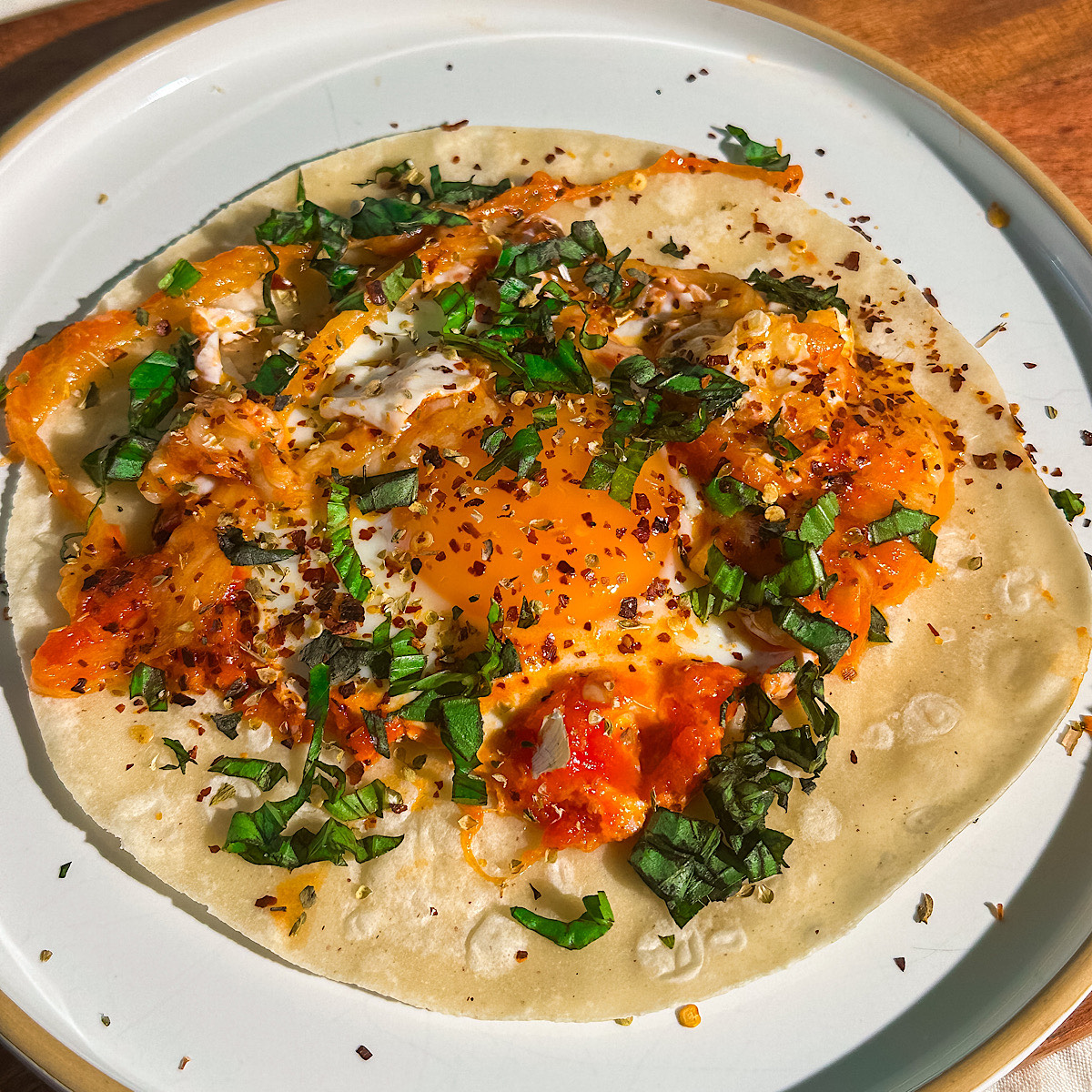 pizza fried egg on a tortilla.