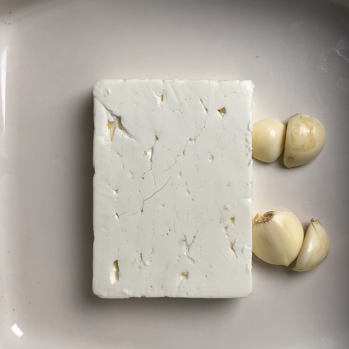 feta and garlic in baking dish