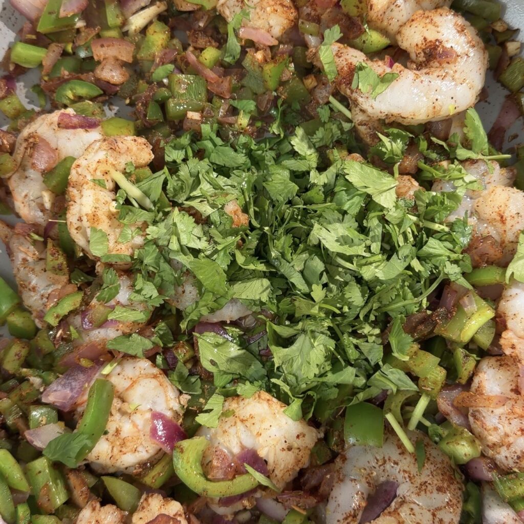 shrimp and veggies cooking in pan