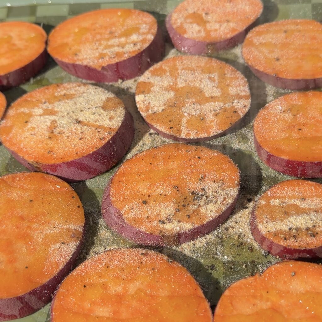 sweet potatoes cooking on sheet pan